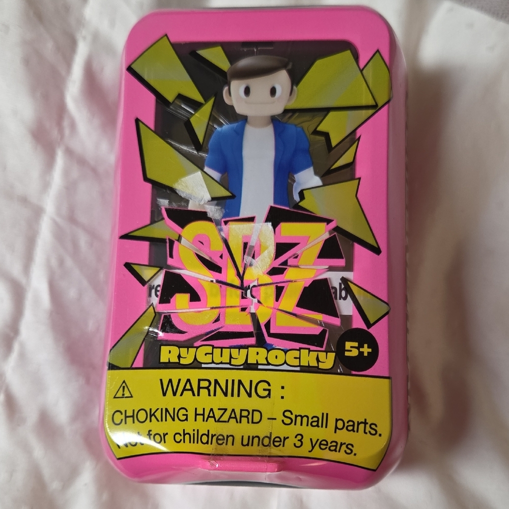 Blue and White Action Figure in Pink Tin